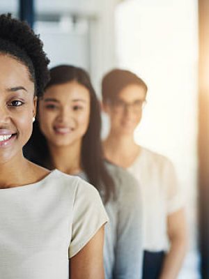 Cropped shot of a group of businesspeople standing in the office